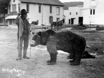 man standing with a bear